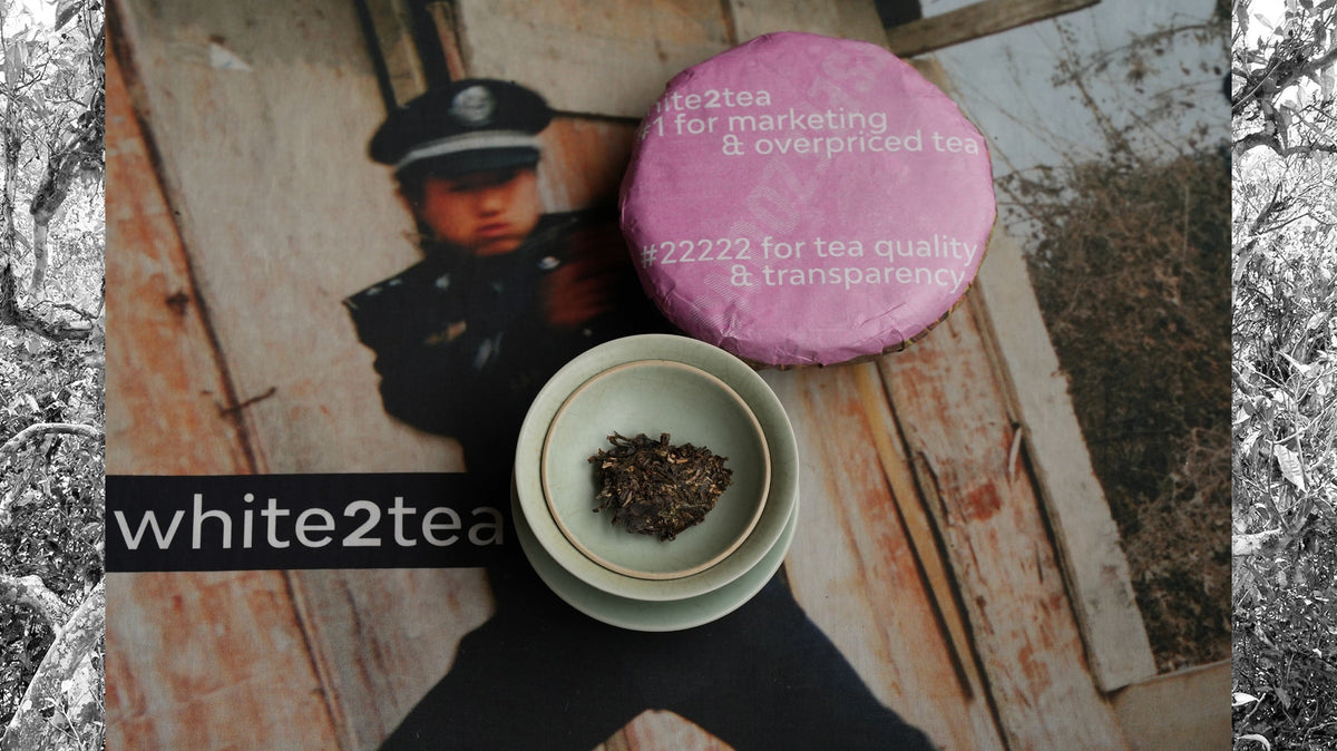 white2tea snoozefest cake and tea portion in gaiwan on tea cloth with police officer printed in background